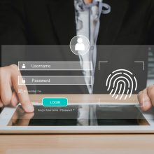 Person hand typing on digital tablet with login and password and fingerprint on screen display, cyber security concept, data protection and secured internet access.